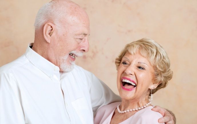 Older couple with dentures smiling