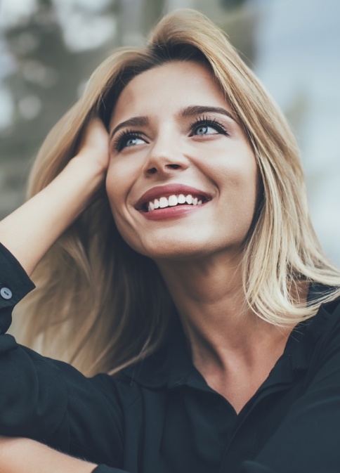 Woman with flawless smile thanks to cosmetic dentistry