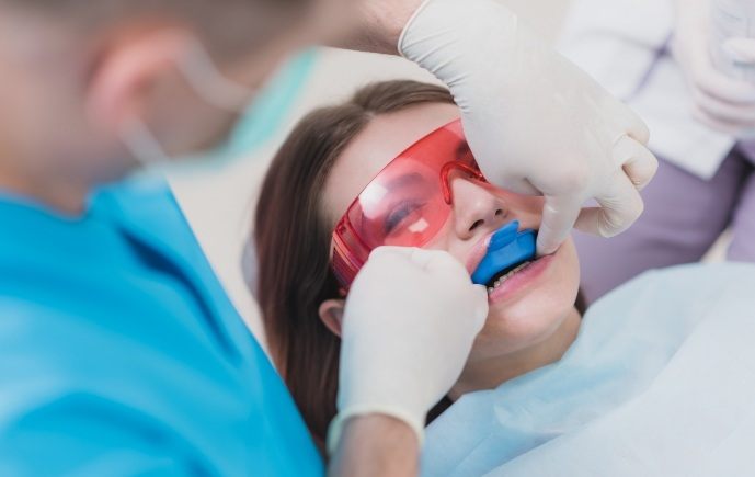 Dentist providing fluoride treatment