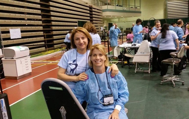 Dentist and dental team member at community event