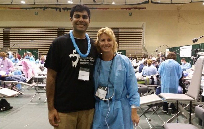 Dentist and dental patient smiling together