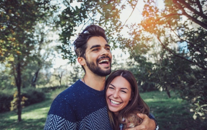 Man and woman smiling after dental checkup and teeth cleaning visit