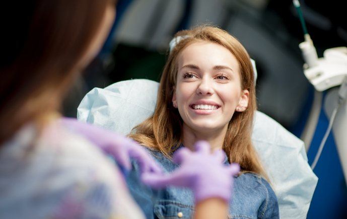 Woman smiling during dental cleaning appointment
