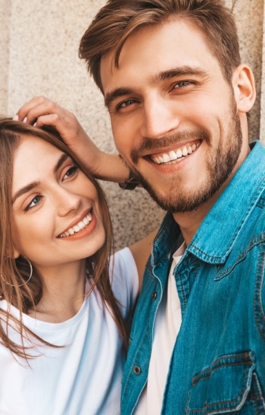 Man and woman with flawless smiles after cosmetic dentistry