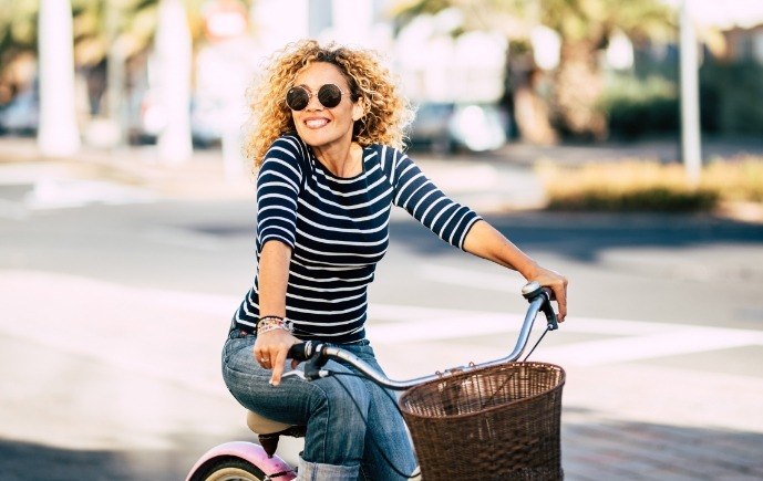 Dentist smiling while riding a bike