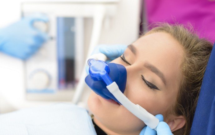 Dental patient receiving nitrous oxide sedation dentistry treatment