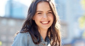 Woman sharing healthy smile after periodontal disease treatment